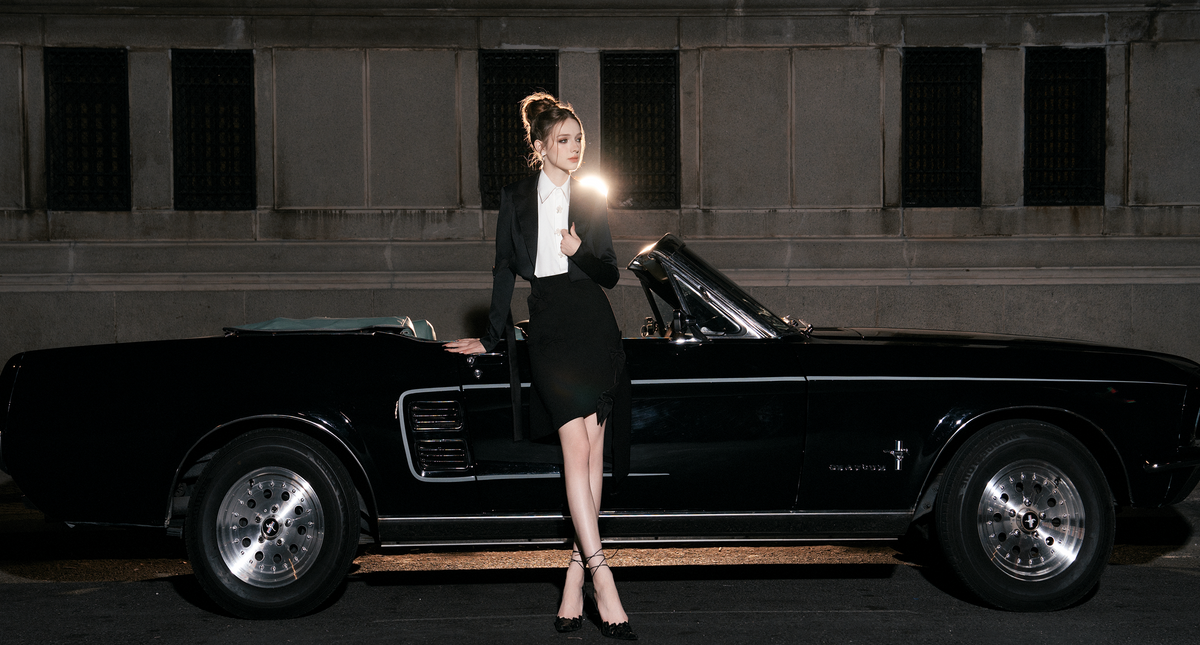 Happy good looking black woman wearing grey leather coat posing beige background autumn winter fashion concept_5